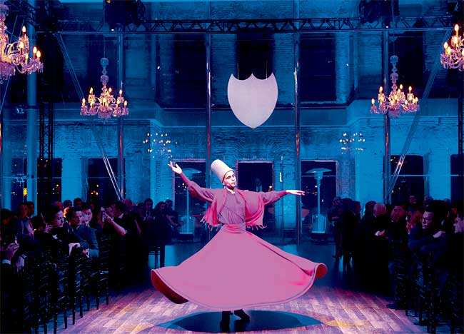 Whirls and wine: A whirling dervish performs before dinner is served on the first floor of a medieval palace Whirls and wine: A whirling dervish performs before dinner is served on the first floor of a medieval palace